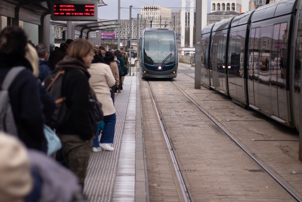 Un tramway bordelais arrive devant un quai bondé.